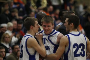 Jamie Jones (middle) gets congratulated by Carterville native Drew Bonner (left) and Du Quoin grad Connor Wheeler after Jones knocked down his eighth-straight 3-pointer. (Photo courtesy Jonathan LeBlond) 