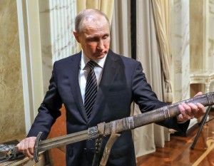 Russian President Vladimir Putin holds a sword while listening an explanations from the head of Russian First Channel Konstantin Ernst, during his meeting with the historical action film Viking's crew, in Moscow, Russia, Friday, Dec. 30, 2016. Viking is a historical action film based on the historical document Primary Chronicle and Icelandic Kings' sagas. (Mikhail Klimentyev, Sputnik, Kremlin Pool Photo via AP)