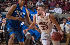 Saluki forward Sean O' Brien drives around Billiken defender Jalon Johnson