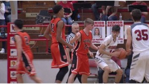 Redbird post player Austin Glodich tries to drive in the post on Jake Downen and DJ Spell (WSIL-TV photo) 