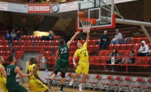 Morthland PG Cody Schultz drives in for a layup over a Crowley's Ridge Defender...