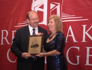 RLCF Board Member Ed Cunningham presents Pat Kern with the commemorative plaque that hangs outside the Pat Kern Private Dining Room in the Rend Lake College Student Center. (RLC Meida Services photo)