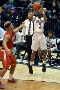 Carbondale's Winslow Martin Pulls up for a three over Centralia's Javon Williams in a home win for the Terriers on December 9th. (Richard Sitler- Southern Illinoisan photo)