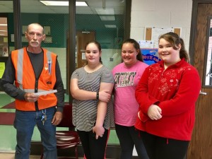 Henry Vaughn accepts the check from CJHS students Kim Martin, Tinley Smith, and Megan Drennan on behalf of the CJHS student body and faculty.  (William McPherson, Photo) 