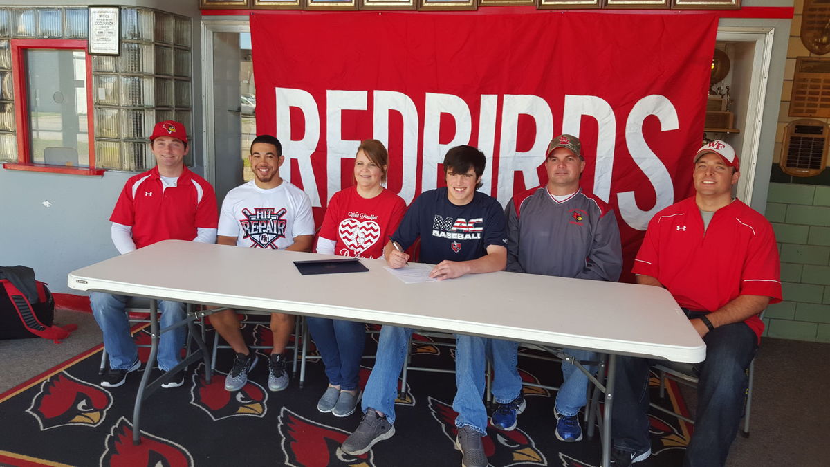 Coach Dustin Hopkins, Chris Dalton, Chrystal Overturf, Peyton Overturf, Jeff Overturf, and Coach Michael Warren at the letter of intent signing yesterday.  (William McPherson Photo)